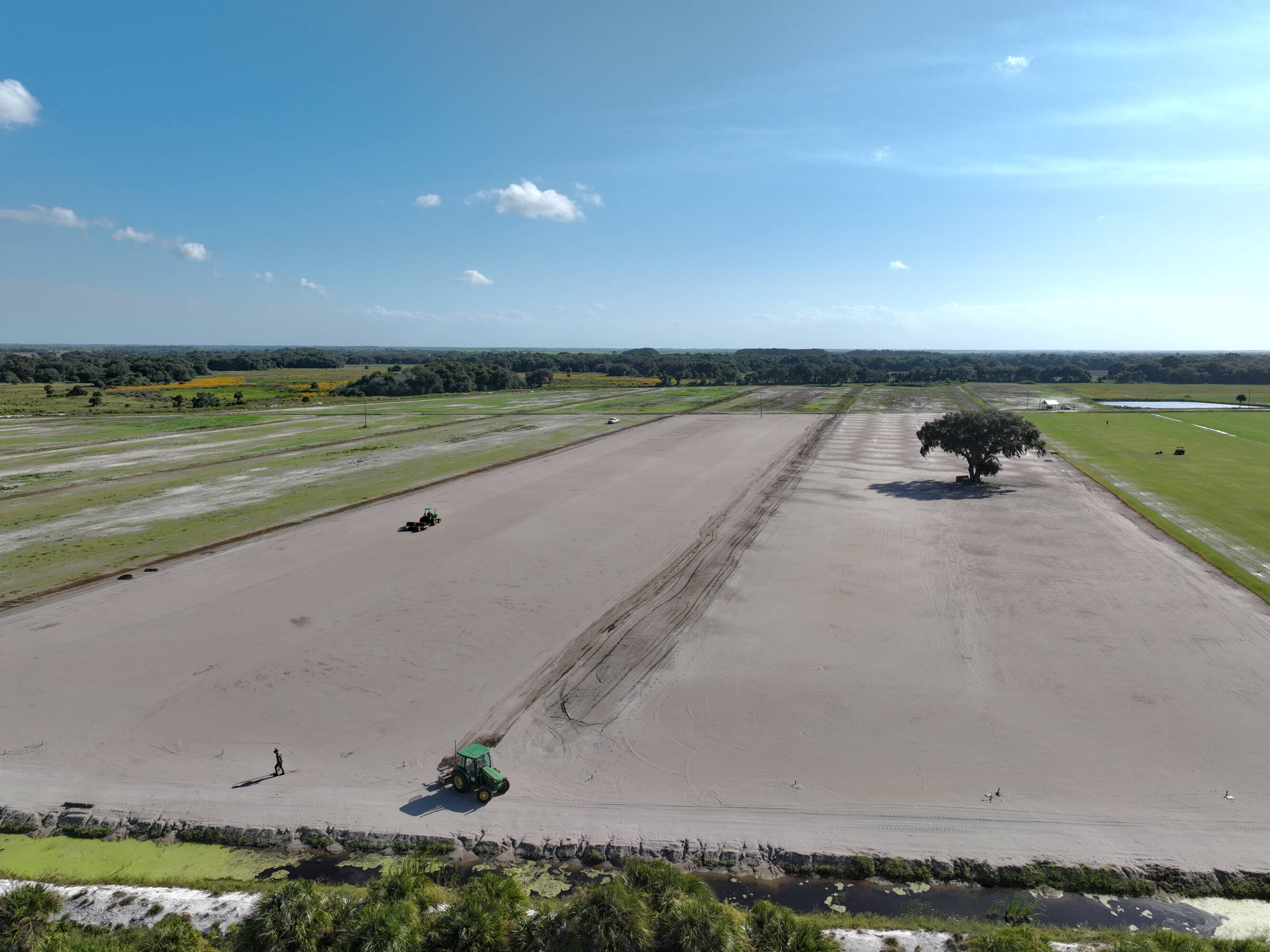 Tractors preparing a sandy field for the next sod planting cycle